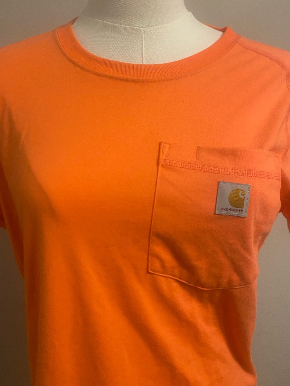 Women’s orange Carhartt T-shirt with chest pocket; Sz small